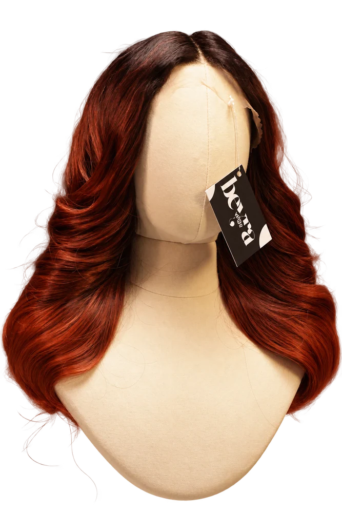 Dark-root auburn wavy wig on a beige mannequin